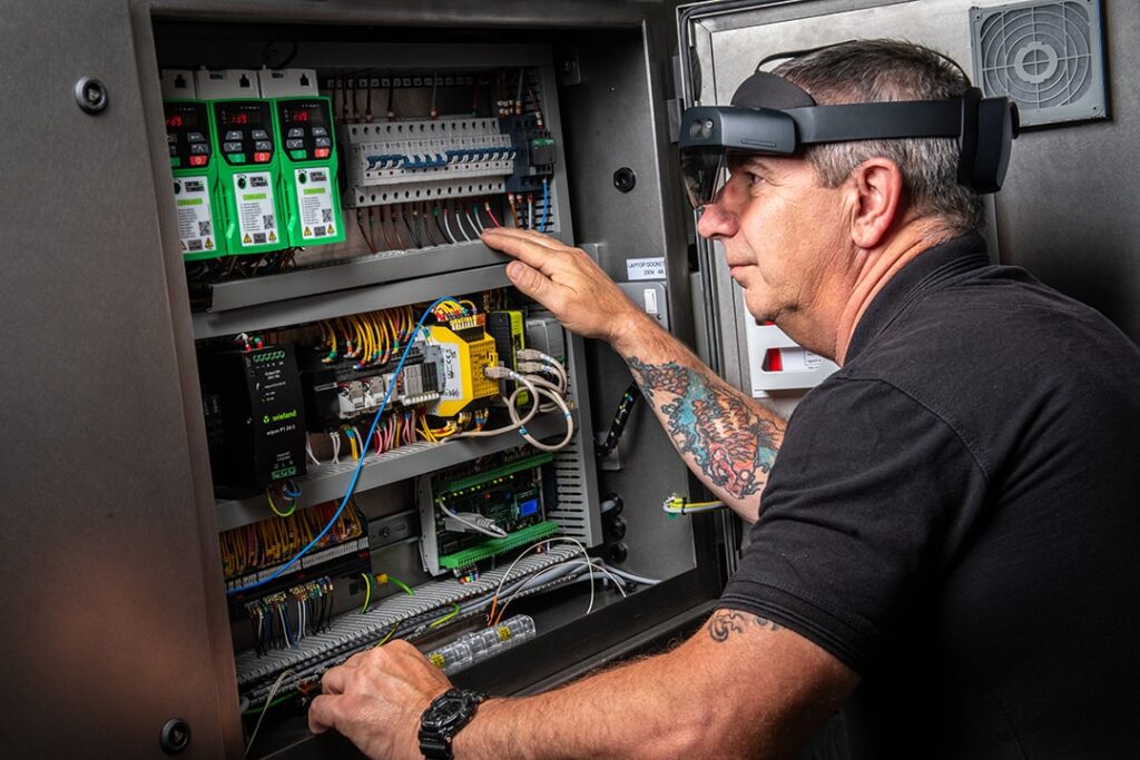 A man wearing a headset operates a control panel, demonstrating concentration and professionalism.