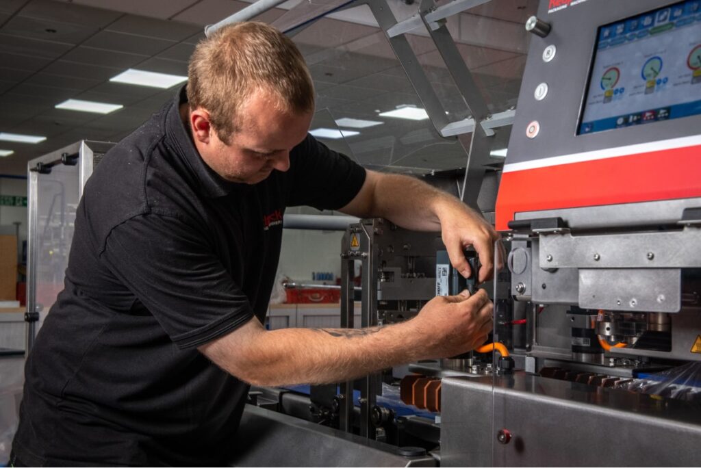 Hayden Lambert working on a Redpack machine